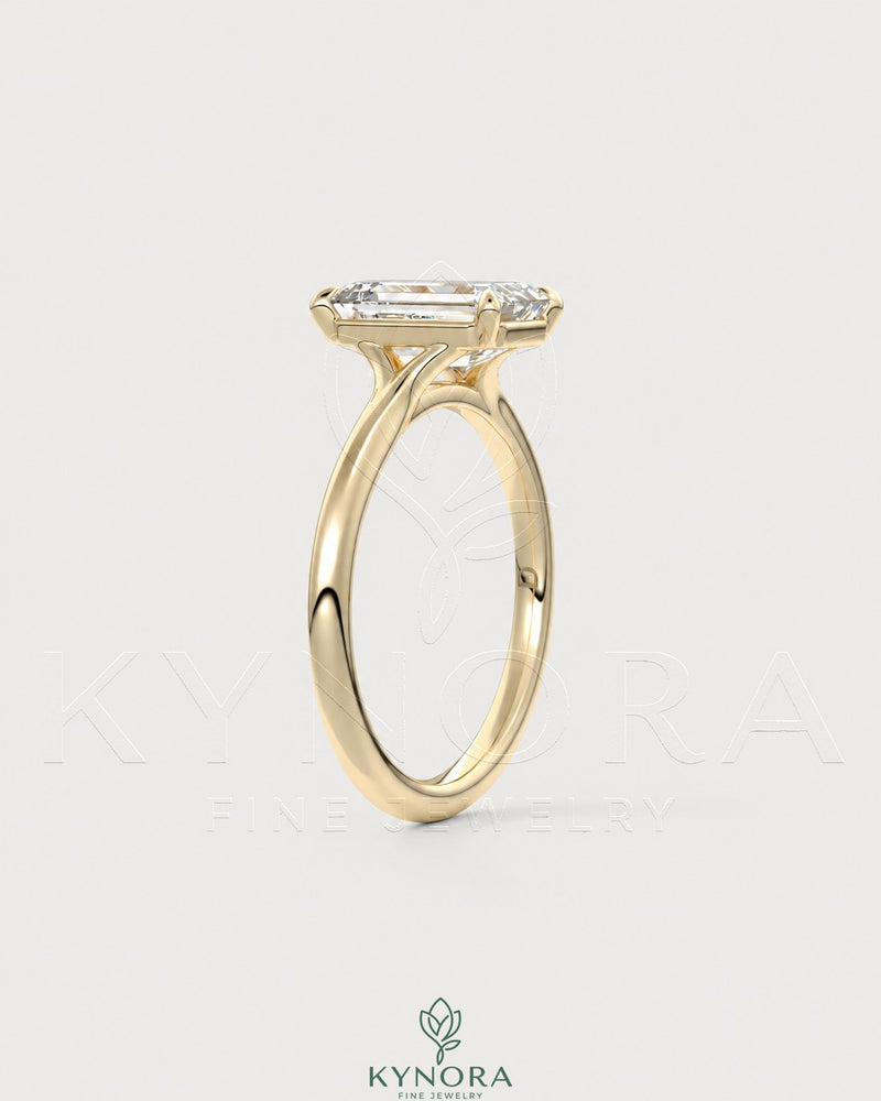 Emerald cut moissanite solitaire engagement ring in 925 sterling silver, featuring a sparkling central gemstone and sleek band.