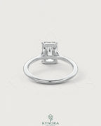 Emerald cut moissanite solitaire engagement ring in 925 sterling silver, featuring a sparkling gemstone setting.