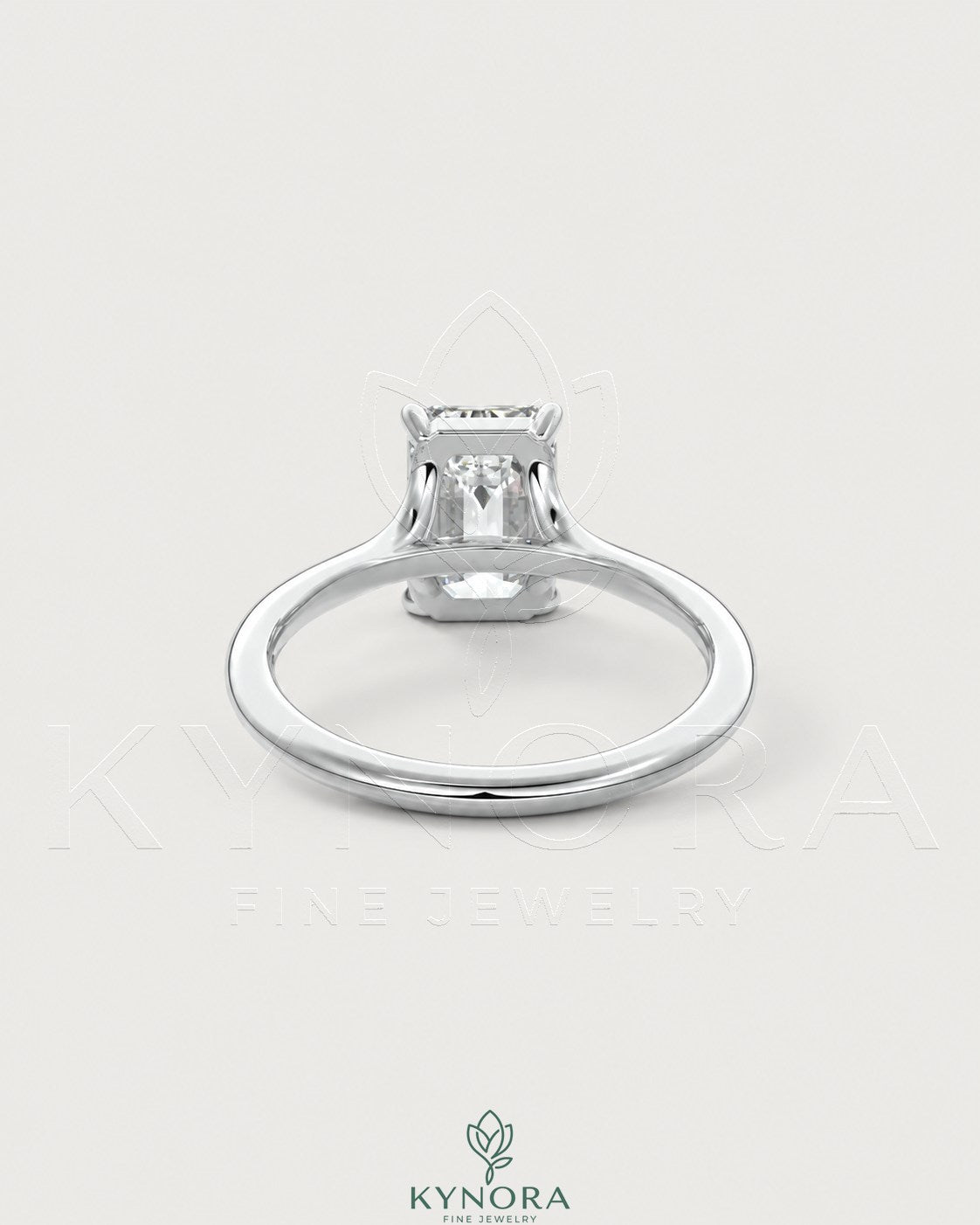 Emerald cut moissanite solitaire engagement ring in 925 sterling silver, featuring a sparkling gemstone setting.