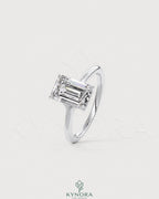 Emerald cut Moissanite solitaire engagement ring in 925 sterling silver with a sleek band and sparkling center stone.