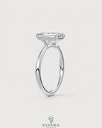 Emerald cut moissanite solitaire engagement ring in 925 sterling silver with a sleek band and sparkling center stone.