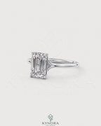 Emerald cut moissanite solitaire engagement ring in 925 sterling silver with a smooth band and sparkling center stone.