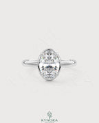 Oval moissanite bezel solitaire engagement ring in 925 silver with a sleek band and sparkling center stone.