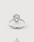 Oval moissanite bezel solitaire engagement ring in 925 silver with a sleek, elegant setting by Kynora CJ.