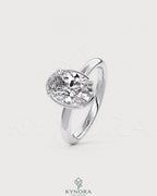 Oval moissanite bezel solitaire engagement ring in 925 silver with a sleek, modern design from Kynora CJ.