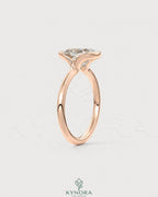 Elongated moissanite half-bezel solitaire ring in 925 silver with a sleek design, by Kynora CJ, displayed on a white background.