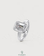 Emerald cut Moissanite bezel engagement ring in 925 silver with a sleek design, featuring a sparkling central stone.