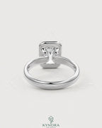 Emerald cut moissanite bezel engagement ring in sterling silver, featuring a sleek design and sparkling center stone.