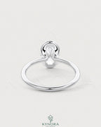 Oval moissanite half-bezel solitaire engagement ring in 925 silver featuring a sleek, elegant design with a prominent central stone.