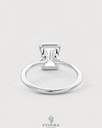 Radiant cut moissanite half-bezel engagement ring in 925 silver, featuring a sleek design and sparkling gemstone from Kynora CJ.