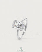 Radiant cut moissanite half-bezel engagement ring in 925 silver with detailed craftsmanship by Kynora CJ.