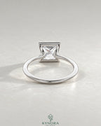 Princess cut moissanite half-bezel solitaire ring in 925 silver with a sleek band, featuring a sparkling center stone.