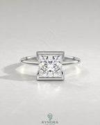 Princess cut moissanite half-bezel solitaire ring in 925 silver with a sleek design, showcasing a sparkling center stone.