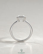 Asscher cut moissanite half-bezel solitaire ring in 925 silver, featuring a sparkling center stone and sleek band design.