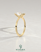 Pear cut moissanite half-bezel engagement ring in 925 silver with a sleek, elegant design displayed on an ivory backdrop.