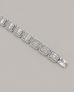 Sterling silver tennis bracelet with baguette stones, worn on white glove, showcasing Kynora Jewels' hip-hop style bracelet.