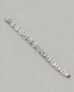 Sterling silver tennis bracelet with baguette diamonds, worn on a white-gloved hand, showcasing Kynora Jewels' hip-hop style jewelry.