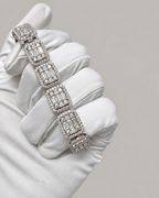 Sterling silver Kynora Jewels hip-hop tennis bustdown bracelet with sparkling stones, displayed on a white glove.