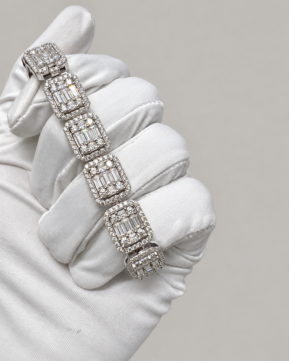 Sterling silver Kynora Jewels hip-hop tennis bustdown bracelet with sparkling stones, displayed on a white glove.