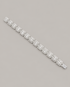 Sterling silver tennis bustdown bracelet by Kynora Jewels featuring sparkling hip-hop style design on neutral background.