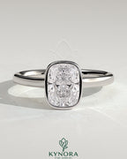 Kynora CJ 2ct elongated cushion bezel solitaire engagement ring with cathedral high setting and elegant gold band.