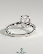 Kynora CJ 2ct elongated cushion bezel solitaire engagement ring with cathedral high setting, showcasing a sparkling diamond and intricate band.