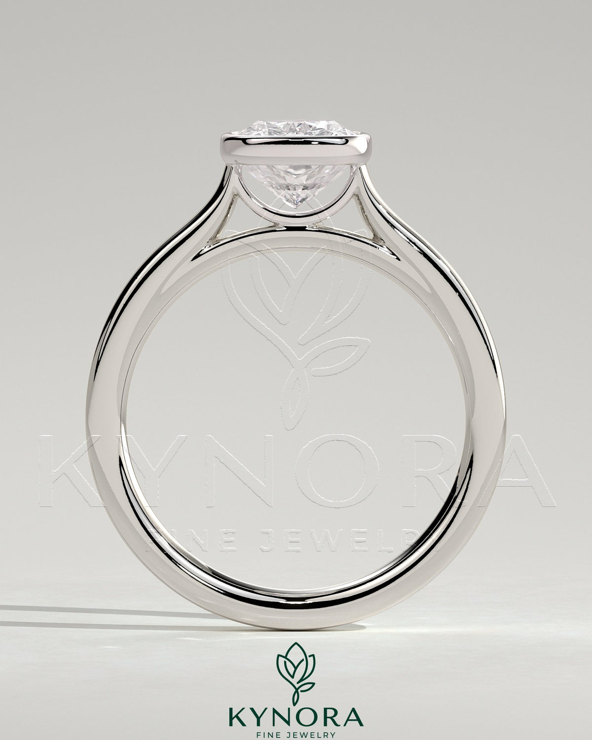 Kynora CJ 2ct elongated cushion bezel solitaire engagement ring with cathedral high setting showcasing a central diamond.