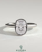 Kynora CJ 2ct elongated cushion bezel solitaire engagement ring with hidden halo and cathedral high setting showcasing intricate details