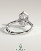 Kynora CJ 2ct elongated hexagon bezel solitaire engagement ring with hidden halo and cathedral high setting, showcasing intricate design.
