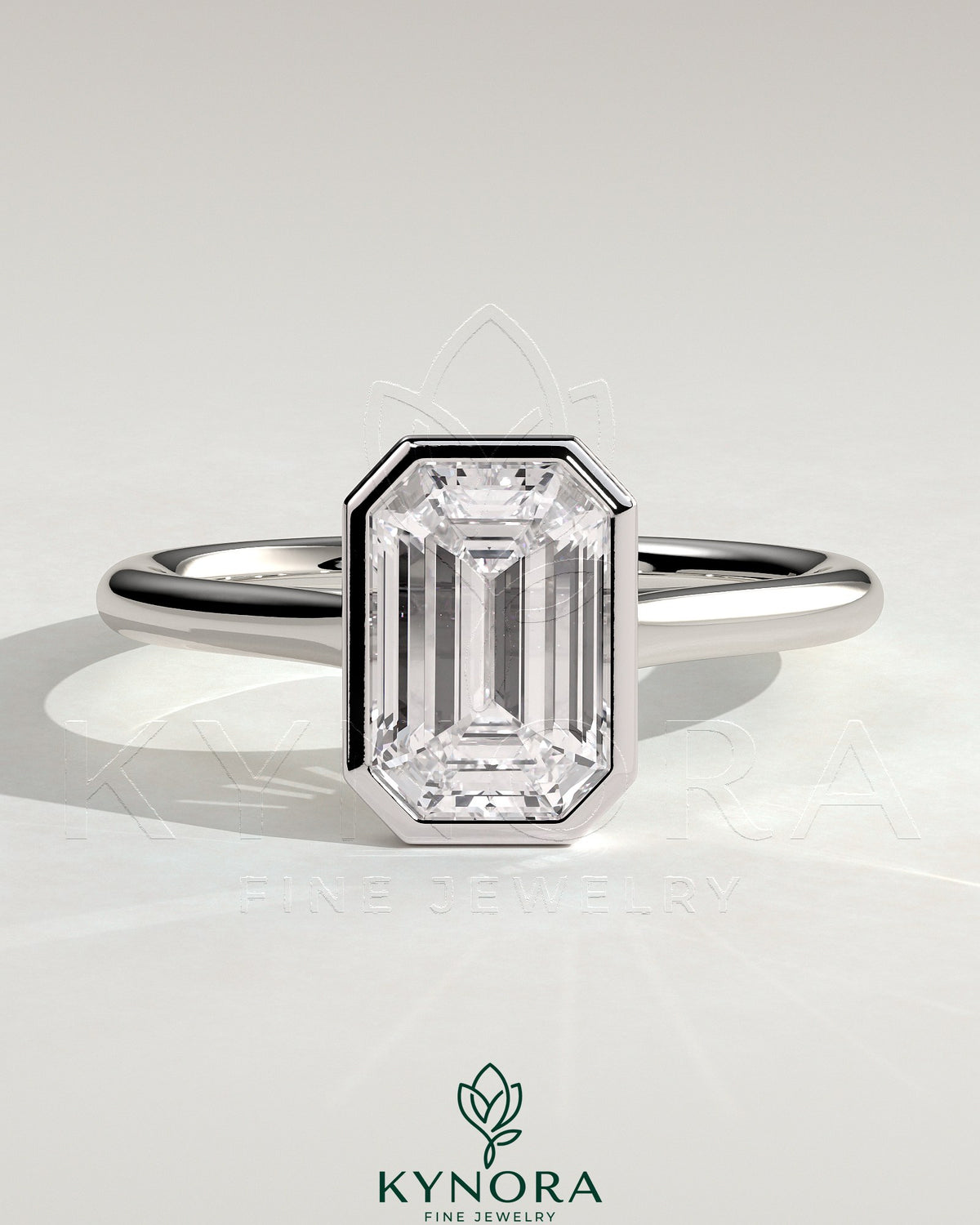 Kynora CJ 2ct emerald bezel solitaire engagement ring with cathedral high setting showcasing a vibrant green emerald gemstone. Main image