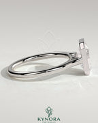 Kynora CJ 2ct emerald bezel solitaire engagement ring with cathedral high setting, showcasing a stunning emerald cut gemstone and elegant band.