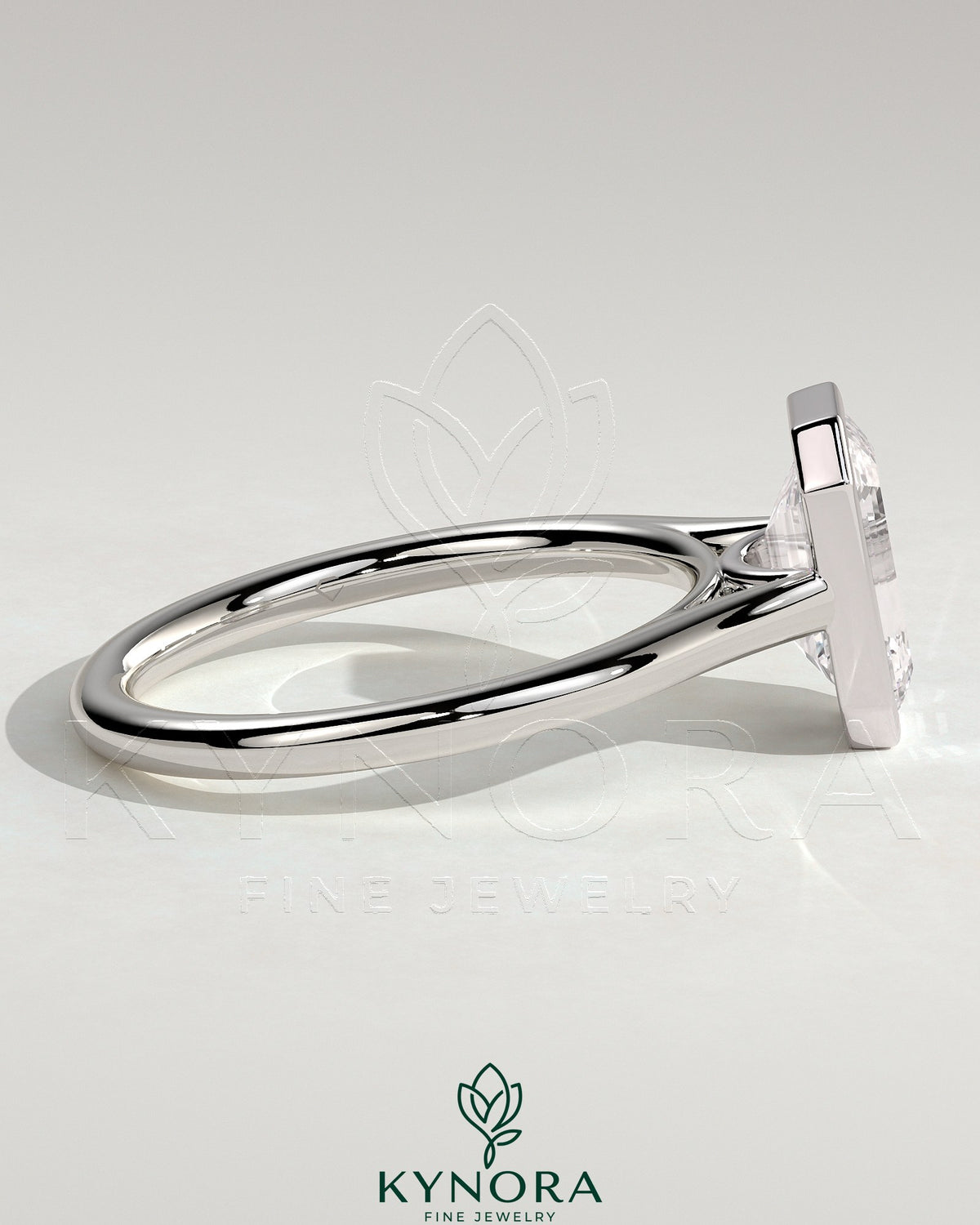 Kynora CJ 2ct emerald bezel solitaire engagement ring with cathedral high setting, showcasing a stunning emerald cut gemstone and elegant band.