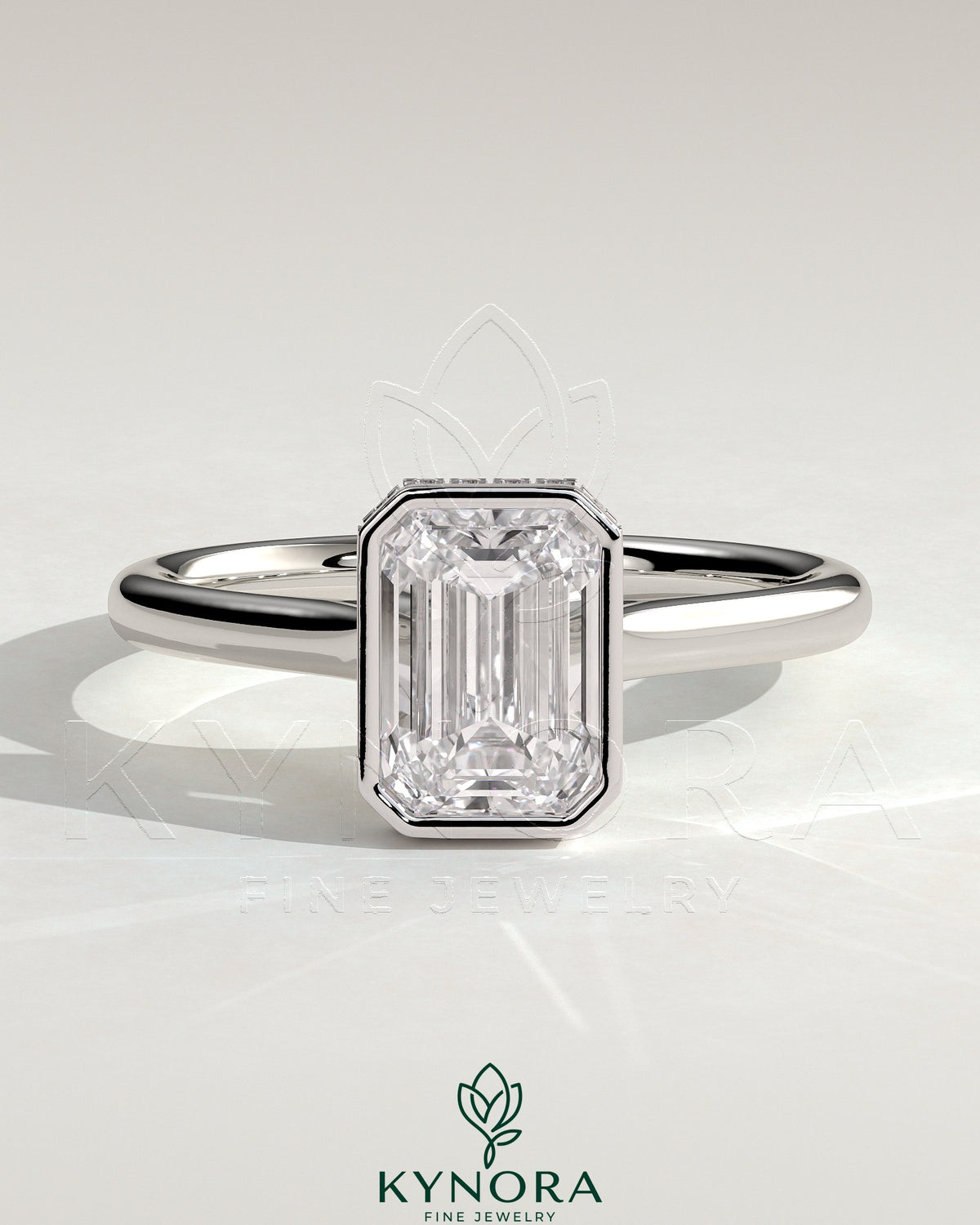 Kynora CJ 2ct emerald bezel solitaire engagement ring with hidden halo and cathedral high setting, showcasing intricate jewelry design.