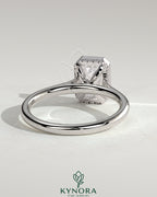 Kynora CJ 2ct emerald bezel solitaire engagement ring with hidden halo and cathedral high setting, showcasing intricate design and craftsmanship.
