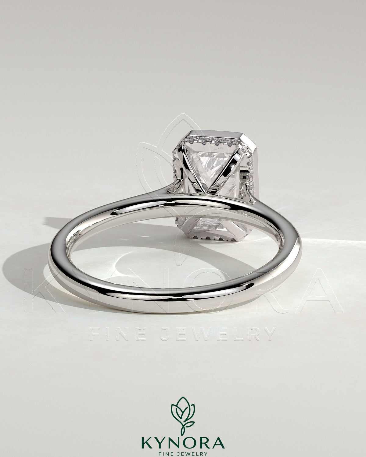 Kynora CJ 2ct emerald bezel solitaire engagement ring with hidden halo and cathedral high setting, showcasing intricate design and craftsmanship.