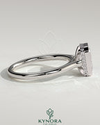 Kynora CJ 2ct emerald bezel solitaire engagement ring with hidden halo and cathedral high setting, showcasing intricate design and sparkling gemstone.