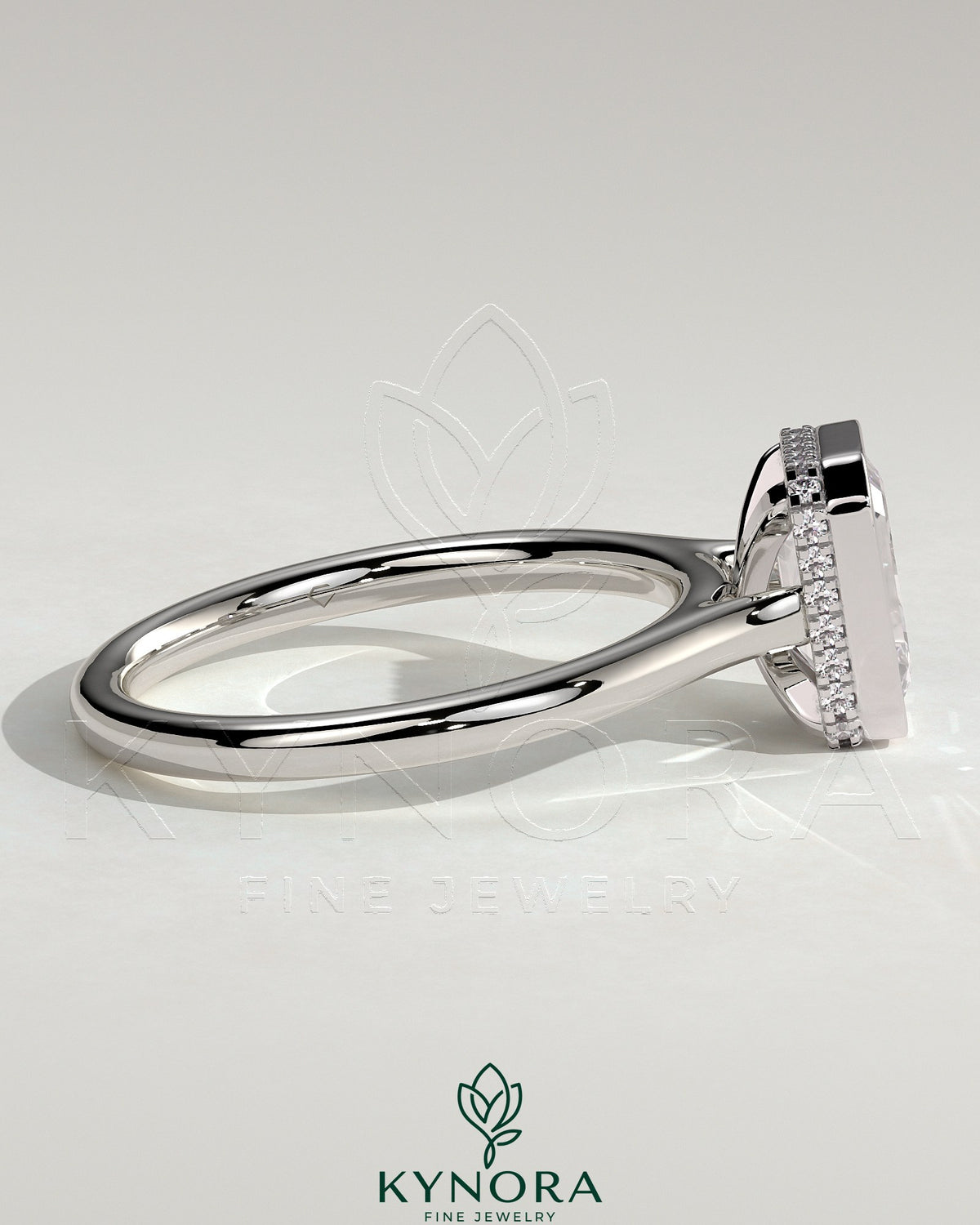 Kynora CJ 2ct emerald bezel solitaire engagement ring with hidden halo and cathedral high setting, showcasing intricate design and sparkling gemstone.