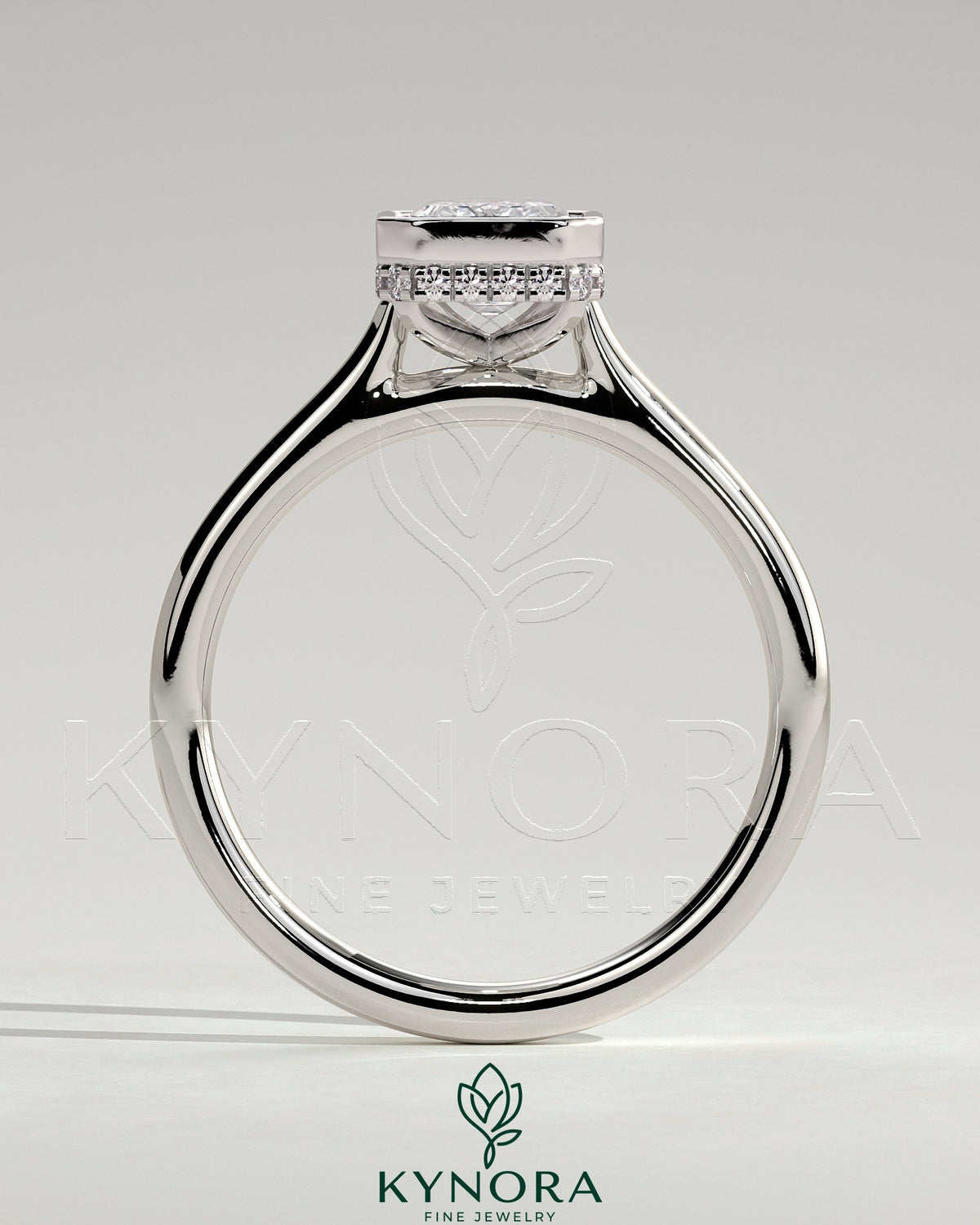 Kynora CJ 2ct emerald bezel solitaire engagement ring with hidden halo and cathedral high setting, showcasing intricate craftsmanship.