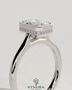 Kynora CJ 2ct emerald bezel solitaire engagement ring with hidden halo and cathedral high setting, showcasing detailed craftsmanship.