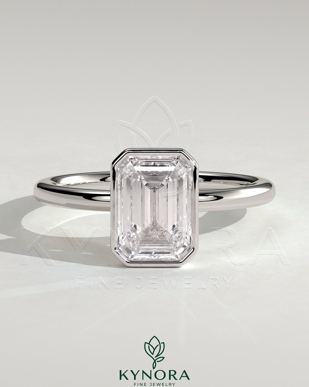 Kynora CJ 2ct emerald bezel solitaire engagement ring with petal gallery design, showcasing a central emerald-cut stone in a detailed setting. Main image