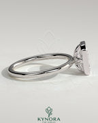 Kynora CJ 2ct emerald bezel solitaire engagement ring with petal gallery design, featuring a central emerald-cut diamond.