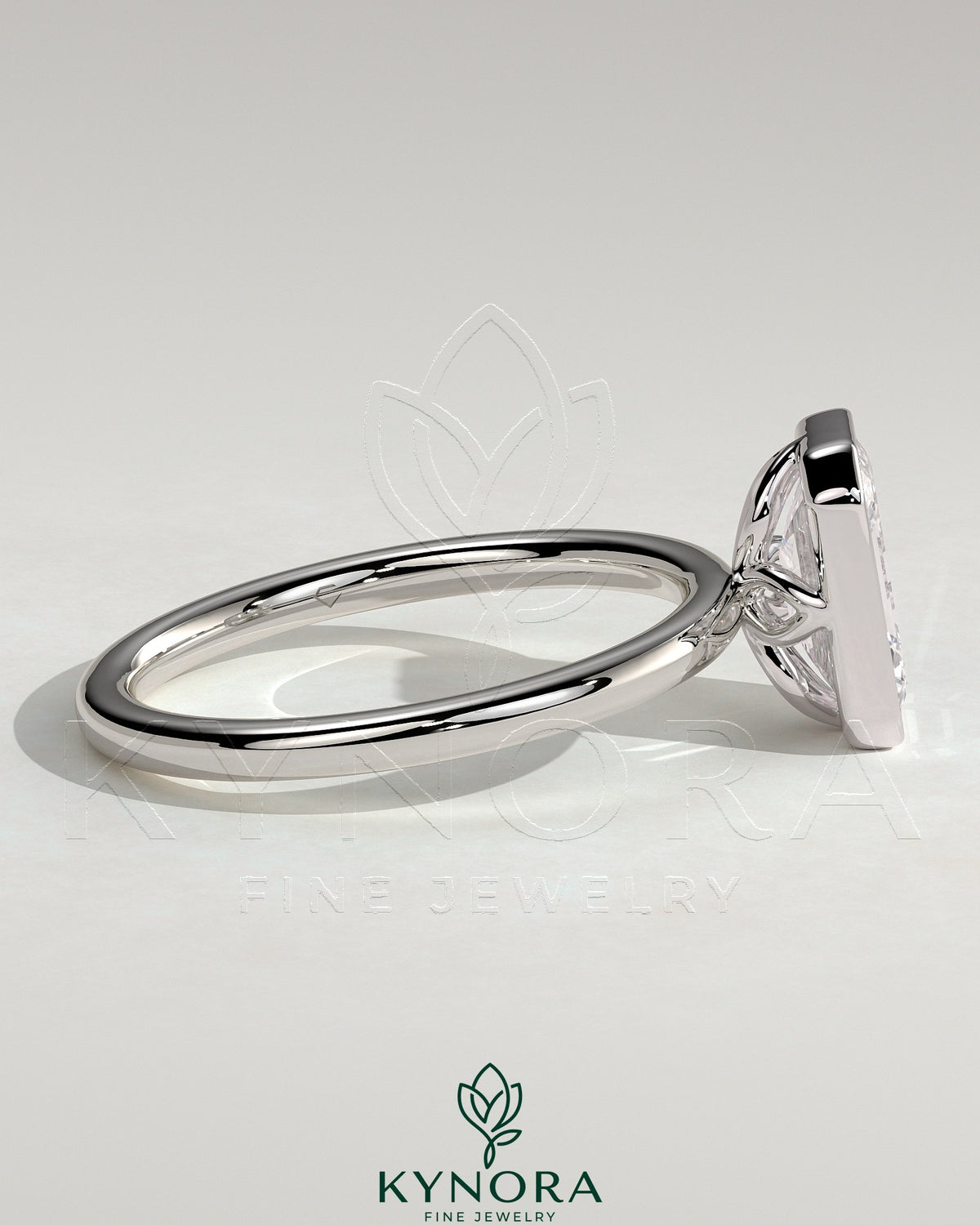 Kynora CJ 2ct emerald bezel solitaire engagement ring with petal gallery design, featuring a central emerald-cut diamond.
