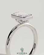 Kynora CJ 2ct emerald bezel solitaire engagement ring with petal gallery design, showcasing a vibrant green emerald set in a sleek bezel.