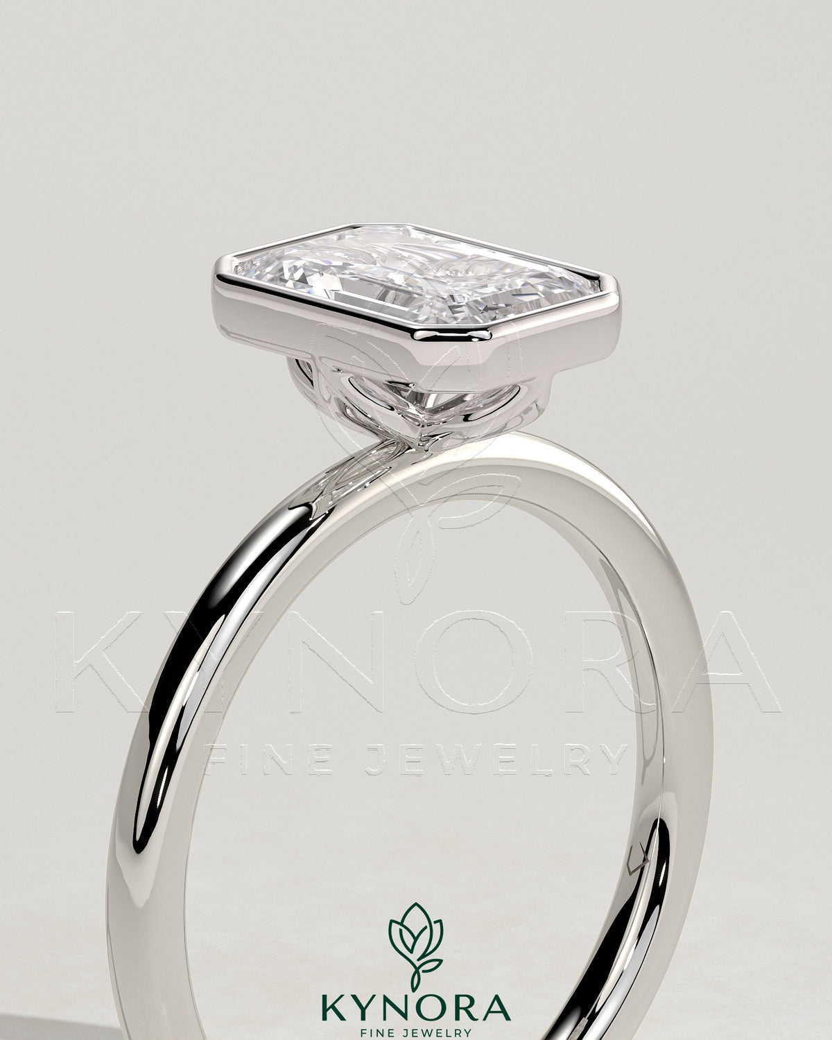 Kynora CJ 2ct emerald bezel solitaire engagement ring with petal gallery design, showcasing a vibrant green emerald set in a sleek bezel.
