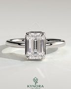 Bezel engagement ring with 2ct emerald claw solitaire diamond set in a sleek bezel frame by Kynora CJ.