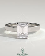 Kynora CJ 2ct emerald claw solitaire bezel engagement ring with flat cigar band and hidden halo, showcasing intricate jewelry design.