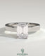 Kynora CJ 2ct emerald claw solitaire bezel engagement ring with flat cigar band and hidden halo, showcasing intricate jewelry design.