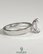 Kynora CJ 2ct emerald claw solitaire engagement ring with flat cigar band and hidden halo, bezel setting, elegant jewelry design