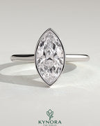 Kynora CJ 2ct marquise bezel solitaire engagement ring with cathedral high setting showcasing a sparkling marquise diamond.