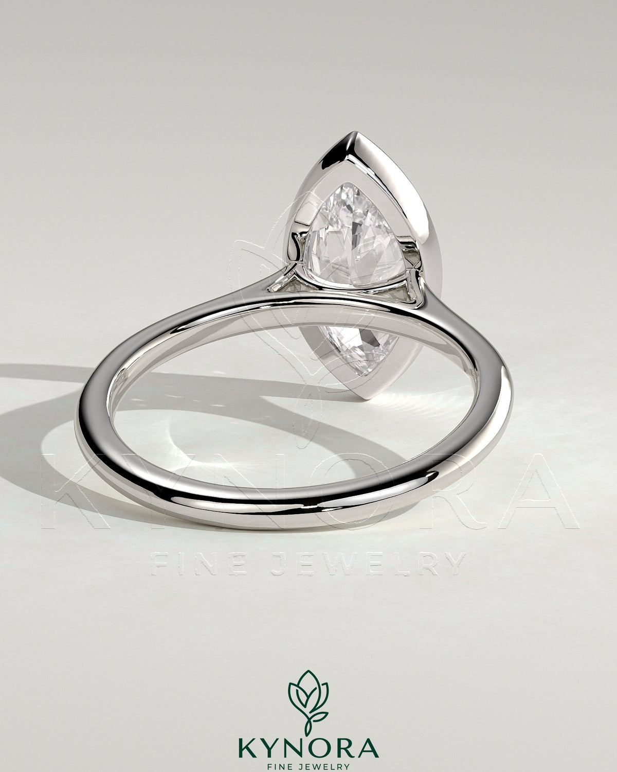 Kynora CJ 2ct marquise bezel solitaire engagement ring with cathedral high setting and intricate metalwork.